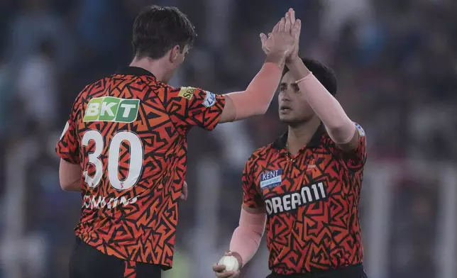 Sunrisers Hyderabad's captain Pat Cummins, left, and Sunrisers Hyderabad's Abhishek Sharma celebrates the dismissal of Gujarat Titans' Jos Butler during the Indian Premier League cricket match between Gujarat Titans and Sunrisers Hyderabad at Narendra Modi Stadium in Ahmedabad, India, Friday, May 2, 2025. (AP Photo/Siddharaj Solanki)
