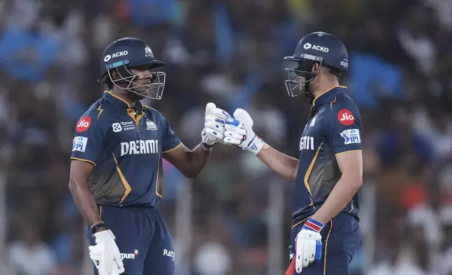 Gujarat Titans' captain Shubman Gill, right, and Sai Sudharsan greets each other during the Indian Premier League cricket match between Gujarat Titans and Sunrisers Hyderabad at Narendra Modi Stadium in Ahmedabad, India, Friday, May 2, 2025. (AP Photo/Siddharaj Solanki)