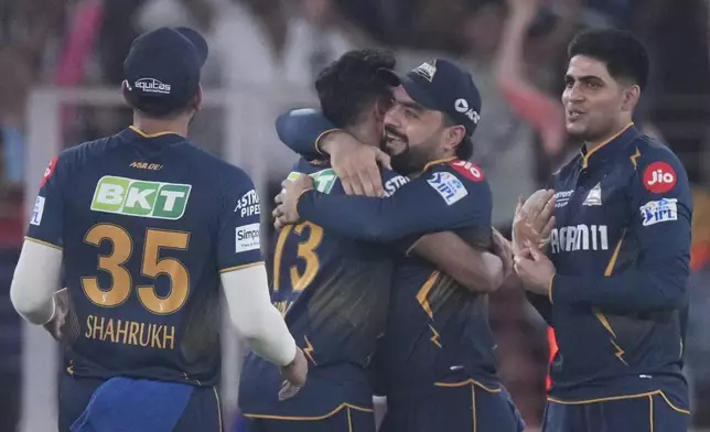 Gujarat Titans players celebrates the dismissal of Sunrisers Hyderabad's Travis Head during the Indian Premier League cricket match between Gujarat Titans and Sunrisers Hyderabad at Narendra Modi Stadium in Ahmedabad, India, Friday, May 2, 2025. (AP Photo/Siddharaj Solanki)
