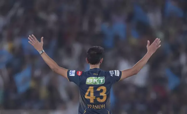 Gujarat Titans' Prasidh Krishna celebrates the dismissal of Sunrisers Hyderabad's Travis Head during the Indian Premier League cricket match between Gujarat Titans and Sunrisers Hyderabad at Narendra Modi Stadium in Ahmedabad, India, Friday, May 2, 2025. (AP Photo/Siddharaj Solanki)