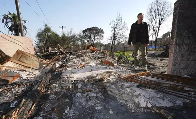 Tim Vordtriede looks at the remains of his property, which was destroyed the Eaton Fire in Altadena, Calif., on Tuesday, April 22, 2025. (AP Photo/Damian Dovarganes)