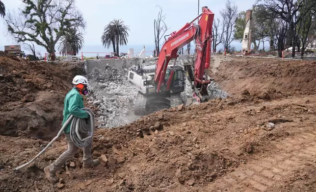 Construction begins on a property damaged by the Palisades Fire in the Pacific Palisades neighborhood of Los Angeles Thursday, April 24, 2025. (AP Photo/Damian Dovarganes)