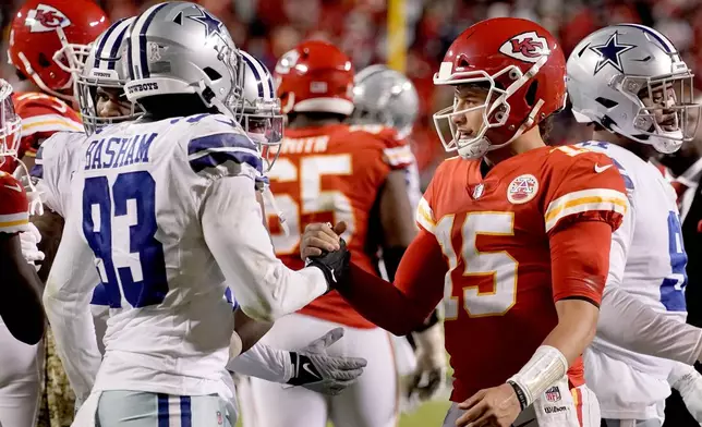 FILE - Kansas City Chiefs quarterback Patrick Mahomes (15) and Dallas Cowboys defensive end Tarell Basham (93) greet each other after an NFL football game, Sunday, Nov. 21, 2021, in Kansas City, Mo. (AP Photo/Charlie Riedel, File)