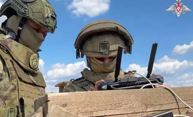 In this photo taken from video distributed by the Russian Defense Ministry Press Service on Monday, May 26, 2025, Russian serviceman train to operate military drones in an undisclosed location. (Russian Defense Ministry Press Service via AP)