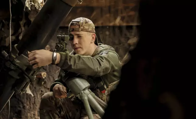 In this photo taken on May 27, 2025 and provided by Ukraine's 24th Mechanized Brigade press service, a soldier prepares a 120mm mortar to fire towards Russian army positions near Chasiv Yar, Donetsk region, Ukraine, Tuesday, May 27, 2025, (Oleg Petrasiuk/Ukraine's 24th Mechanized Brigade via AP)