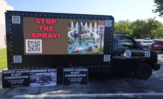 A truck outside a Florida Fish &amp; Wildlife Commission hearing about proposed bear hunting with signs against the hunt Wednesday, May 21, 2025, in Ocala, Fla. (AP Photo/John Raoux)