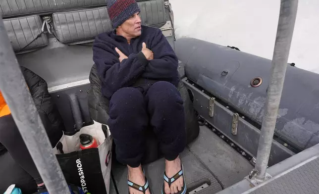 Endurance swimmer Louis Pugh warms up on the ride back to shore after completing the first leg of his swim around Martha's Vineyard, Thursday, May 15, 2025, off Edgartown, Mass. (AP Photo/Robert F. Bukaty)