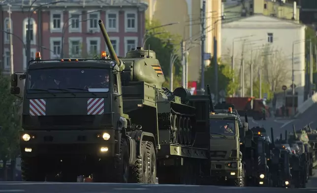 Russian military trucks carrying Soviet T-34 battle tanks roll along the Garden Ring towards the Red Square prior to the Victory Day military parade rehearsal in Moscow, Russia, Saturday, May 3, 2025. (AP Photo/Pavel Bednyakov)