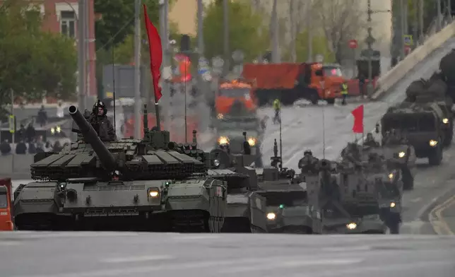 Russian armoured vehicles and tanks roll along a street toward Red Square to attend a rehearsal for the Victory Day military parade in Moscow, Russia, on Tuesday, April 29, 2025. (AP Photo/Alexander Zemlianichenko)