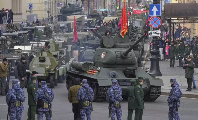 A Soviet era T-34 tank leads a column of military vehicles during a rehearsal for the Victory Day military parade at the Dvortsovaya (Palace) Square in St. Petersburg, Russia, Wednesday, April 30, 2025. (AP Photo/Dmitri Lovetsky)