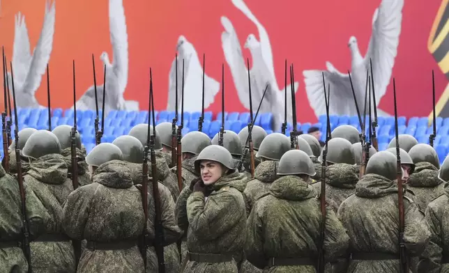 Russian army servicemen wearing Soviet army helmets stand during a rehearsal for the Victory Day military parade at the Dvortsovaya (Palace) Square in St. Petersburg, Russia, Monday, May 5, 2025. (AP Photo/Dmitri Lovetsky)
