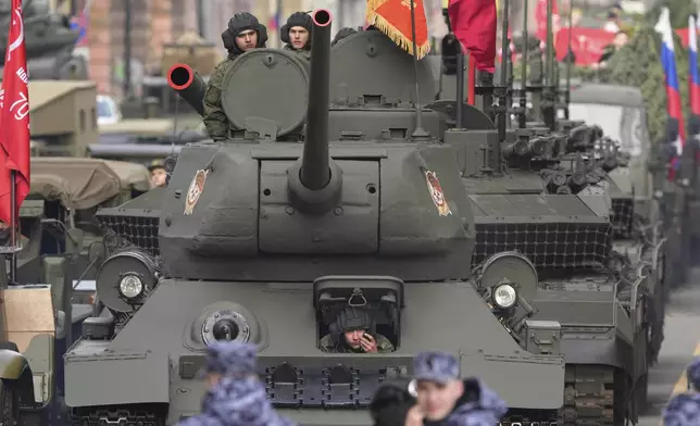A Soviet era T-34 tank leads a column of military vehicles during a rehearsal for the Victory Day military parade at the Dvortsovaya (Palace) Square in St. Petersburg, Russia, Wednesday, April 30, 2025. (AP Photo/Dmitri Lovetsky)