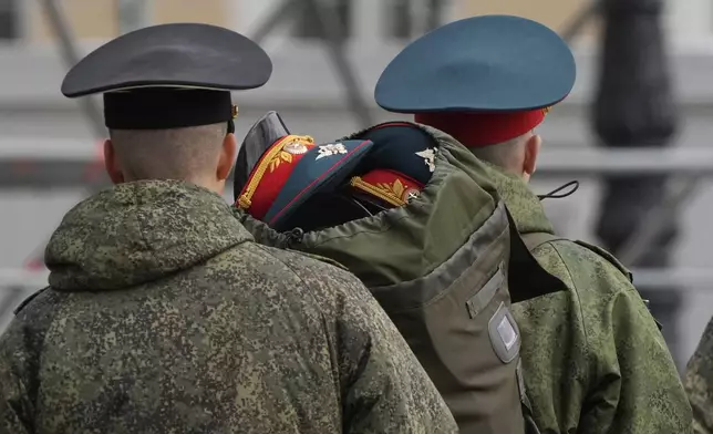 Honour guard soldiers carry caps prior to a rehearsal for the Victory Day military parade at the Dvortsovaya (Palace) Square in St. Petersburg, Russia, Wednesday, April 30, 2025. (AP Photo/Dmitri Lovetsky)