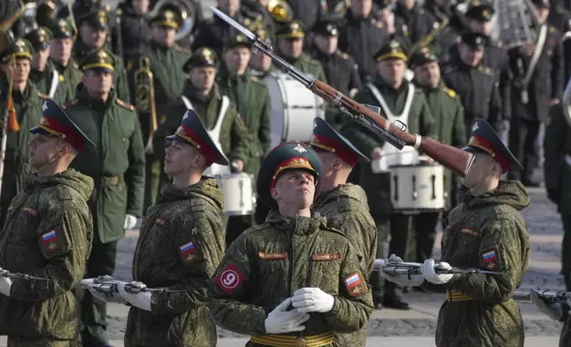 Honour guard soldiers perform with guns during a rehearsal for the Victory Day military parade at the Dvortsovaya (Palace) Square in St. Petersburg, Russia, Wednesday, April 30, 2025. (AP Photo/Dmitri Lovetsky)