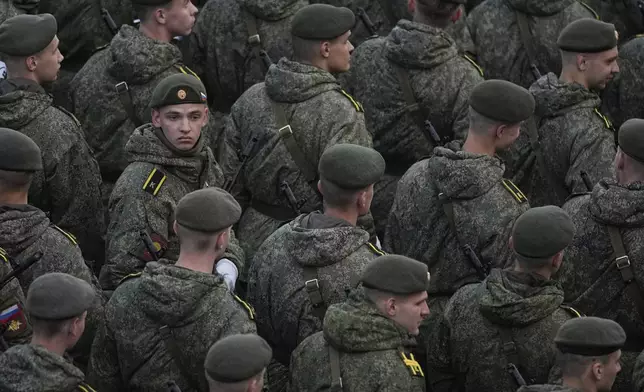 Russian servicemen gather at Ustyinskaya embankment prior to the Victory Day military parade rehearsal at the Red Square in Moscow, Russia, Saturday, May 3, 2025. (AP Photo/Pavel Bednyakov)