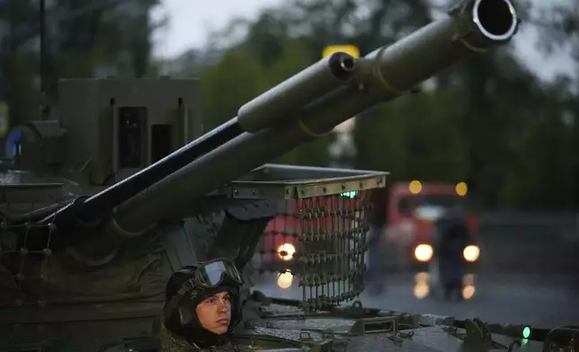 A driver sits in a tank driving along Tverskaya street toward Red Square to attend a rehearsal for the Victory Day military parade in Moscow, Russia, on Tuesday, April 29, 2025. (AP Photo/Pavel Bednyakov)