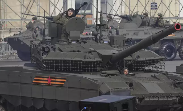 Russian tanks and APCs roll during a rehearsal for the Victory Day military parade at the Dvortsovaya (Palace) Square in St. Petersburg, Russia, Wednesday, April 30, 2025. (AP Photo/Dmitri Lovetsky)