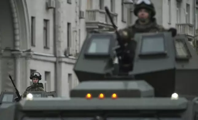 Russian servicemen sit in VPK-Ural armoured vehicle driving along Tverskaya street toward Red Square to attend a rehearsal for the Victory Day military parade in Moscow, Russia, on Tuesday, April 29, 2025. (AP Photo/Pavel Bednyakov)