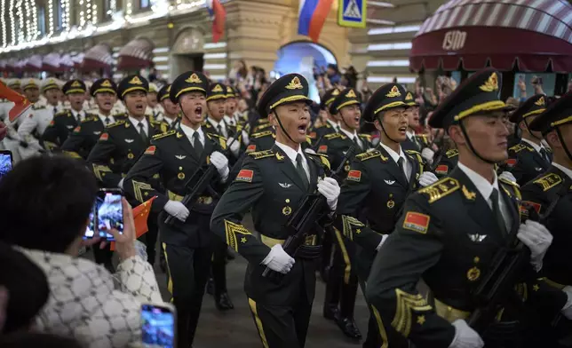 Chinese People's Liberation Army soldiers march past the GUM department store toward Red Square to attend a rehearsal for the Victory Day military parade in Moscow, Russia, on Saturday, May 3, 2025. (AP Photo/Alexander Zemlianichenko)