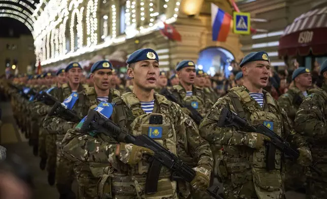 Kazakhstan Army soldiers march past the GUM department store toward Red Square to attend a rehearsal for the Victory Day military parade in Moscow, Russia, on Saturday, May 3, 2025. (AP Photo/Alexander Zemlianichenko)