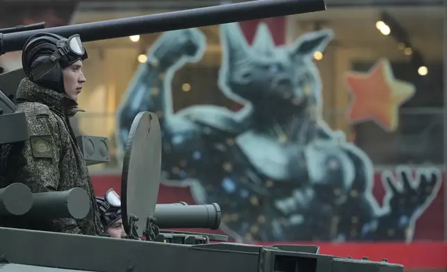 Russian soldiers sit at a tank driving along Tverskaya street to attend a rehearsal for the Victory Day military parade in Moscow, Russia, on Tuesday, April 29, 2025. (AP Photo/Pavel Bednyakov)