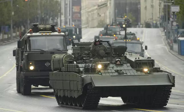 Russian armoured vehicles roll along a street toward Red Square to attend a rehearsal for the Victory Day military parade in Moscow, Russia, on Tuesday, April 29, 2025. (AP Photo/Pavel Bednyakov)