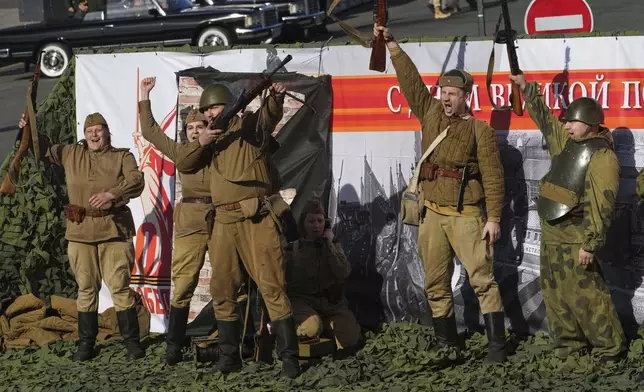 Actors wearing Soviet army uniform ride on a moving platform during a rehearsal for the Victory Day military parade at the Dvortsovaya (Palace) Square in St. Petersburg, Russia, Saturday, May 3, 2025. (AP Photo/Dmitri Lovetsky)