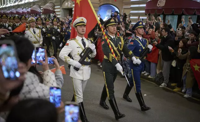 Chinese People's Liberation Army soldiers march past the GUM department store toward Red Square to attend a rehearsal for the Victory Day military parade in Moscow, Russia, on Saturday, May 3, 2025. (AP Photo/Alexander Zemlianichenko)