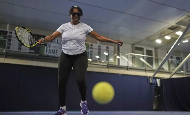 Marvel Opara, who is partially sighted, attends a visually impaired tennis training session in London, Wednesday, May 14, 2025. (AP Photo/Kin Cheung)