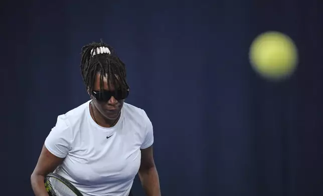 Marvel Opara, who is partially sighted, attends a visually impaired tennis training session in London, Wednesday, May 14, 2025. (AP Photo/Kin Cheung)