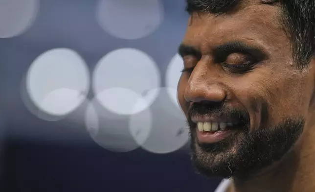 Blind tennis champion Naqi Rizvi attends a visually impaired tennis training session in London, Tuesday, May 20, 2025. (AP Photo/Kin Cheung)