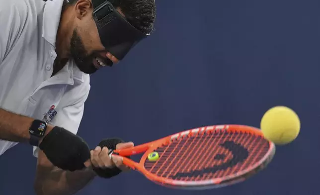Blind tennis champion Naqi Rizvi plays a shot during a visually impaired tennis training session in London, Tuesday, May 20, 2025. (AP Photo/Kin Cheung)