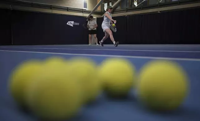 Yasmina Sekkat, who is partially sighted, plays a shot during a visually impaired tennis training session in London, Wednesday, May 14, 2025. (AP Photo/Kin Cheung)