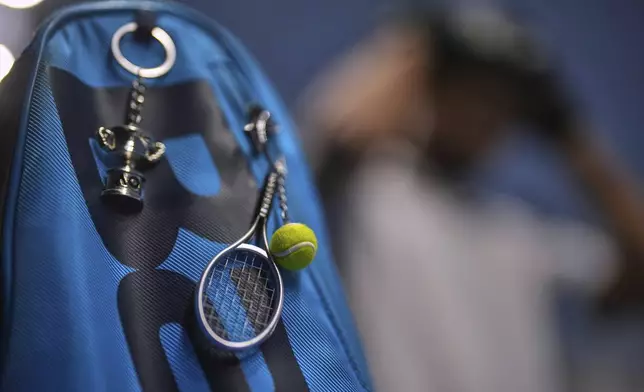 Key rings hang from the bag of blind tennis champion Naqi Rizvi at a visually impaired tennis training session in London, Tuesday, May 20, 2025. (AP Photo/Kin Cheung)