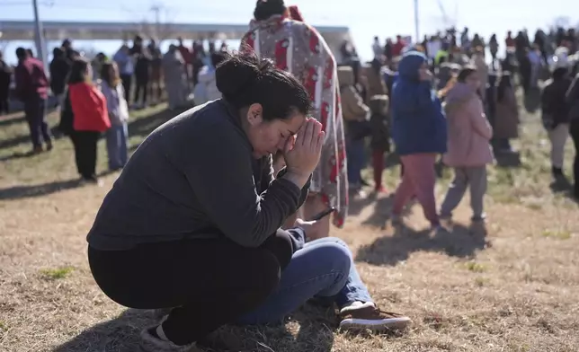 FILE -Dasia Pleitez prays as she waits for her daughter at a unification site following a shooting at the Antioch High School in Nashville, Tenn., Wednesday, Jan. 22, 2025. (AP Photo/George Walker IV, File)
