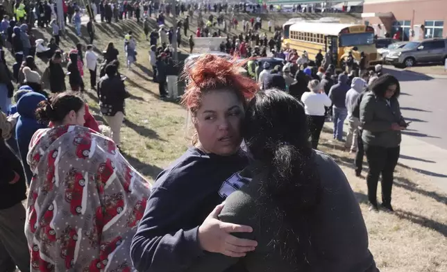 FILE - Families wait as school buses arrive at a unification site following a shooting at the Antioch High School in Nashville, Tenn., Wednesday, Jan. 22, 2025. (AP Photo/George Walker IV, File)