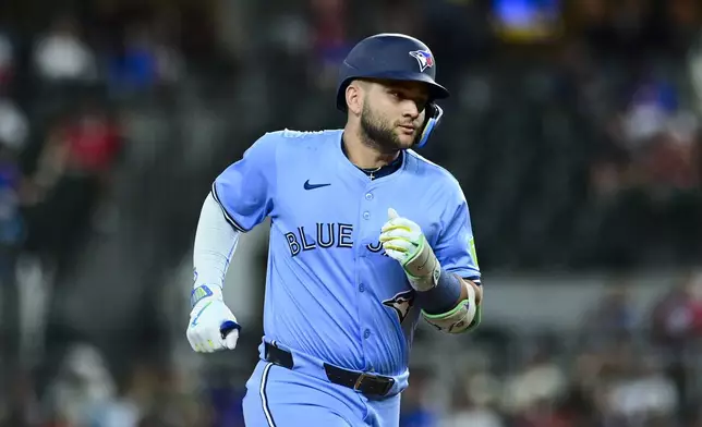 Toronto Blue Jays' Bo Bichette runs the bases after scoring a home run against the Texas Rangers during the ninth inning of a baseball game Wednesday, May 28, 2025, in Arlington, Texas. (AP Photo/Ronaldo Bolaños)