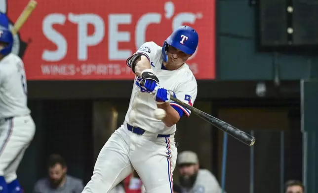Texas Rangers' Corey Seager swings at a ball during the first inning of a baseball game against the Toronto Blue Jays, Wednesday, May 28, 2025, in Arlington, Texas. (AP Photo/Ronaldo Bolaños)