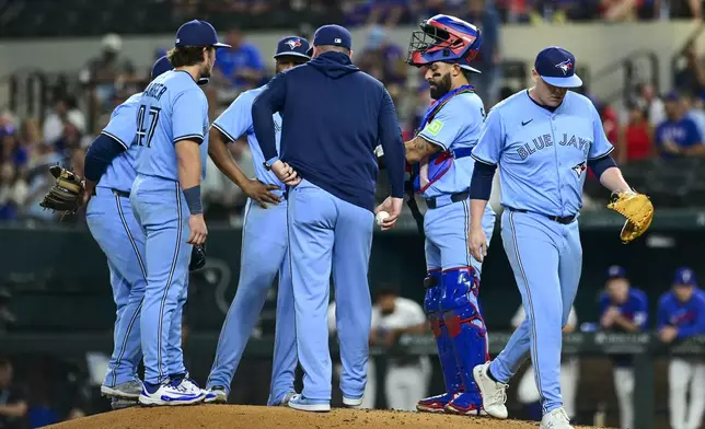 Toronto Blue Jays' starting pitcher Paxton Schultz walks back to the dugout after being taken out of the game during the third inning of a baseball game against the Texas Rangers, Wednesday, May 28, 2025, in Arlington, Texas. (AP Photo/Ronaldo Bolaños)