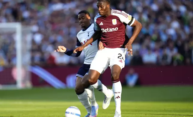 Aston Villa's Amadou Onana, right, and Tottenham Hotspur's Wilson Odobert battle for the ball during the English Premier League soccer match between Aston Villa and Tottenham Hotspur at Villa Park, Birmingham, England, Friday, May 16, 2025. (Nick Potts/PA via AP)