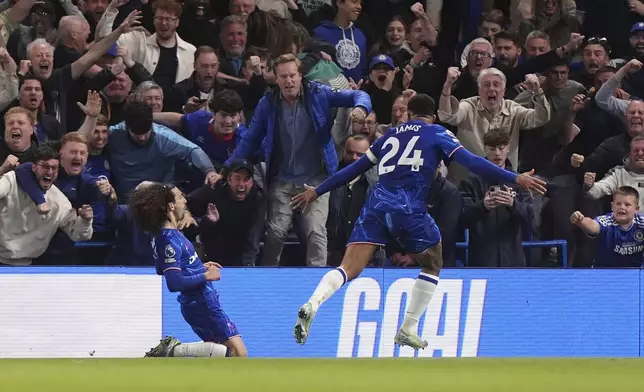 Chelsea's Marc Cucurella, left, celebrates scoring their side's first goal of the game during the English Premier League soccer match between Chelsea and Manchester United at Stamford Bridge, London, Friday, May 16, 2025. (Bradley Collyer/PA via AP)