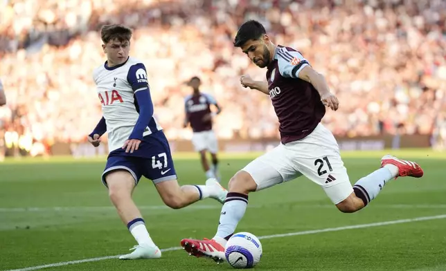 Aston Villa's Marco Asensio (right) and Tottenham Hotspur's Mikey Moore battle for the ball during the English Premier League soccer match between Aston Villa and Tottenham Hotspur at Villa Park, Birmingham, England, Friday, May 16, 2025. (Nick Potts/PA via AP)