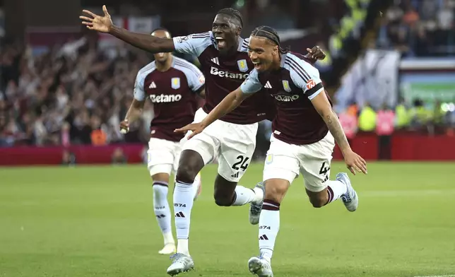 Aston Villa's Boubacar Kamara, right, celebrates scoring their side's second goal of the game with team-mates during their English Premier League soccer match against Tottenham Hotspur at Villa Park, Birmingham, England, Friday, May 16, 2025. (Nick Potts/PA via AP)