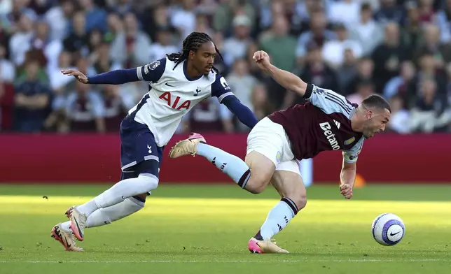 Aston Villa's John McGinn, right, and Tottenham Hotspur's Djed Spence battle for the ball during the English Premier League soccer match between Aston Villa and Tottenham Hotspur at Villa Park, Birmingham, England, Friday, May 16, 2025. (Nick Potts/PA via AP)