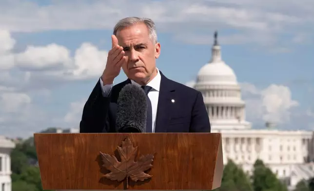 Canada's Prime Minister Mark Carney gestures to a reporter as he takes questions during a news conference at the Canadian embassy in Washington, Tuesday, May 6, 2025. (Adrian Wyld/The Canadian Press via AP)