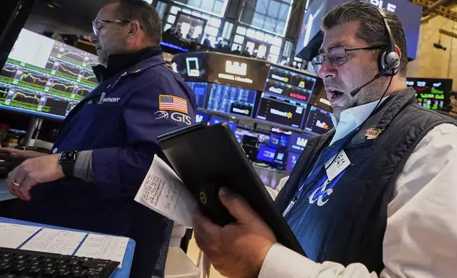 Specialist Anthony Matesic, left, and trader Michael Capolino work on the floor of the New York Stock Exchange, Tuesday, May 20, 2025. (AP Photo/Richard Drew)