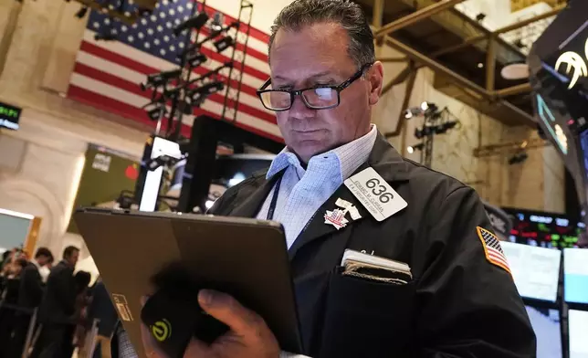 Trader Edward Curran works on the floor of the New York Stock Exchange, Tuesday, May 20, 2025. (AP Photo/Richard Drew)