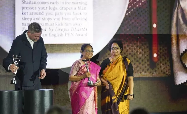 Banu Mushtaq, author of 'Heart Lamp', left, and Deepa Bhasthi react after winning the International Booker Prize, in London, Tuesday, May 20, 2025.(AP Photo/Alberto Pezzali)