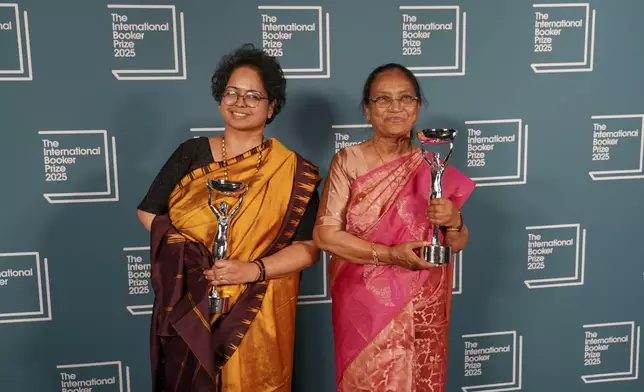 Banu Mushtaq, author of 'Heart Lamp', right, and Deepa Bhasthi hold the trophies after winning the International Booker Prize, in London, Tuesday, May 20, 2025.(AP Photo/Alberto Pezzali)