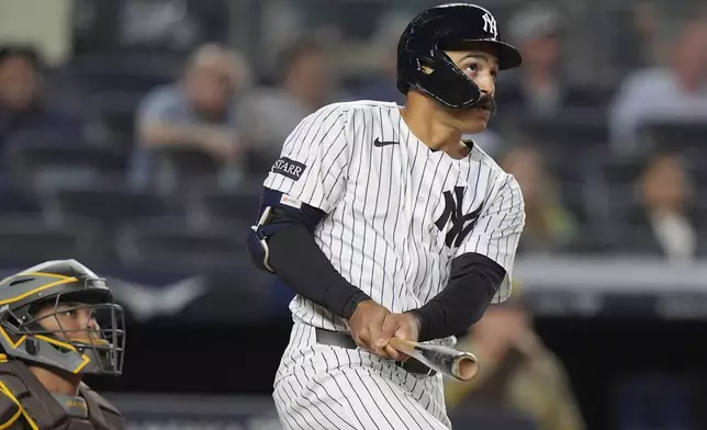 New York Yankees' Trent Grisham watches a ball he hit for a two-run home run during the eighth inning of a baseball game against the San Diego Padres Wednesday, May 7, 2025, in New York. (AP Photo/Frank Franklin II)